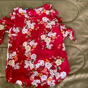 Cute red flowery shirt. It’s open a little bit on the arm sleeves! Super cute!